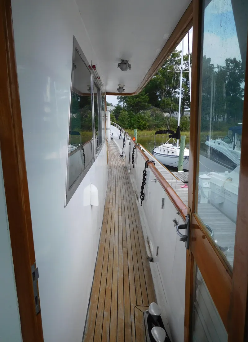 Slide: The Image of Side deck of 1983 Cheoy Lee 90 cockpit motor yacht with wooden flooring. - 16