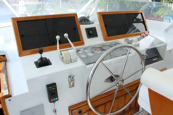 Slide: The Image of Helm of 1983 Cheoy Lee 90 cockpit motor yacht with wooden accents and steering wheel. - 19