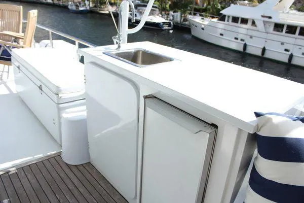 Slide: The Image of Cheoy Lee 90 cockpit motor yacht 1983, featuring outdoor sink and seating area. - 20