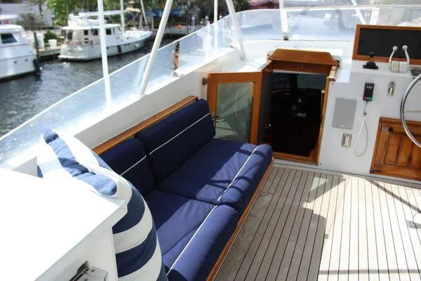Slide: The Image of 1983 Cheoy Lee 90 cockpit motor yacht with blue seating and wooden deck. - 21