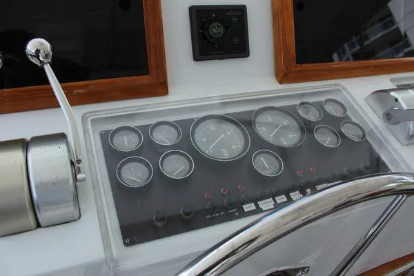 Slide: The Image of Control panel of 1983 Cheoy Lee 90 cockpit motor yacht with gauges and steering wheel. - 23