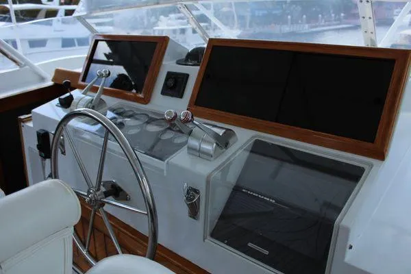 Slide: The Image of 1983 Cheoy Lee 90 cockpit motor yacht helm with steering wheel and control panels. - 24