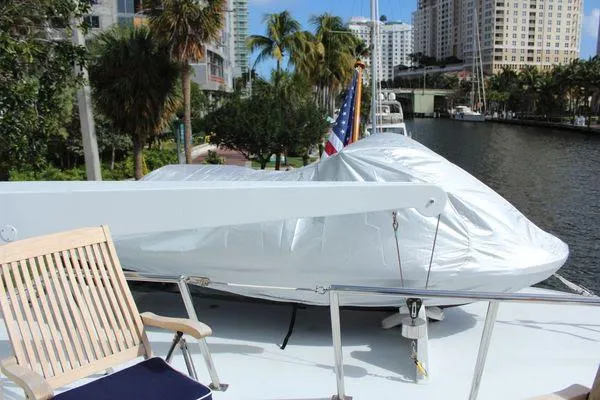 Slide: The Image of 1983 Cheoy Lee 90 cockpit motor yacht deck with covered equipment and chair. - 25