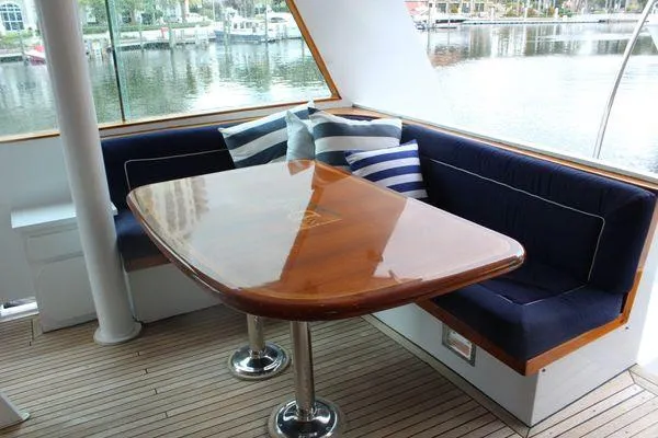 Slide: The Image of Elegant dining area on 1983 Cheoy Lee 90 cockpit motor yacht with polished wood table. - 27