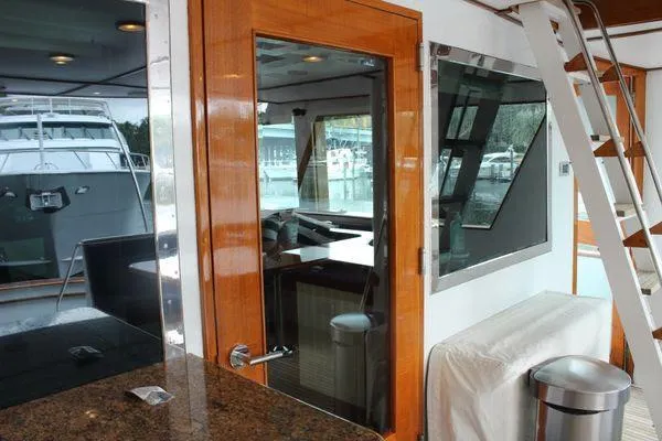 Slide: The Image of Interior view of 1983 Cheoy Lee 90 cockpit motor yacht with wooden accents and modern amenities. - 31