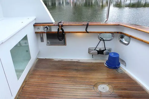 Slide: The Image of Cockpit of 1983 Cheoy Lee 90 motor yacht with wooden deck and blue bucket. - 39