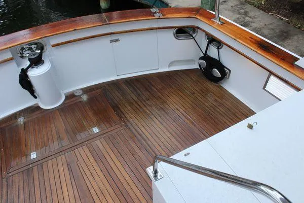 Slide: The Image of 1983 Cheoy Lee 90 cockpit motor yacht with teak deck and white railings. - 40