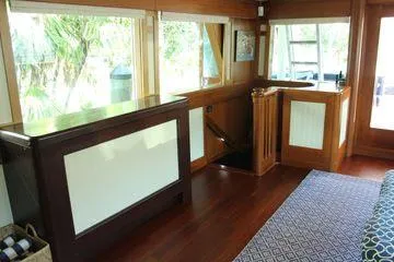 Slide: The Image of Interior of 1983 Cheoy Lee 90 cockpit motor yacht with wood paneling and large windows. - 42