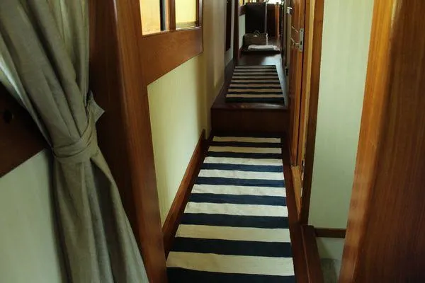 Slide: The Image of Interior hallway of 1983 Cheoy Lee 90 cockpit motor yacht with striped carpet. - 46