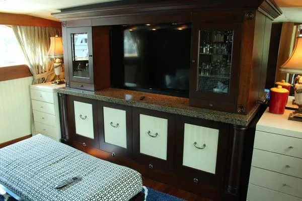 Slide: The Image of Luxurious interior of 1983 Cheoy Lee 90 cockpit motor yacht with elegant cabinetry and TV. - 48