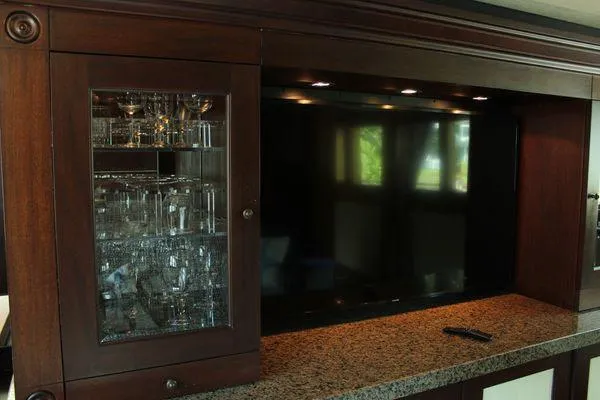 Slide: The Image of Luxurious interior of 1983 Cheoy Lee 90 cockpit motor yacht with glass cabinet and TV. - 49