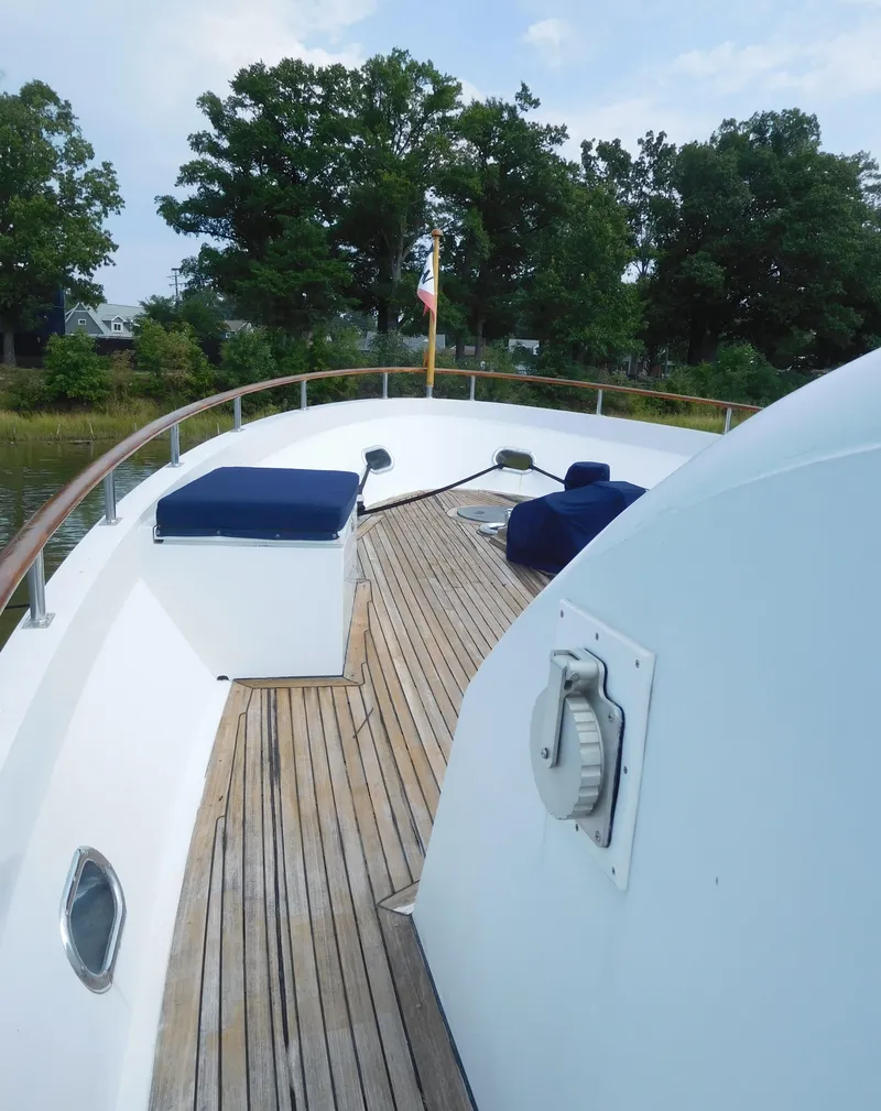 Slide: The Image of 1983 Cheoy Lee 90 cockpit motor yacht deck with wooden flooring and seating. - 5