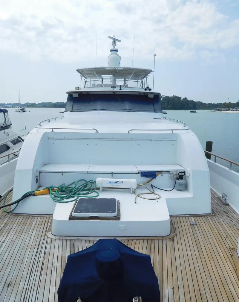 Slide: The Image of 1983 Cheoy Lee 90 cockpit motor yacht docked, featuring spacious deck and sleek design. - 8