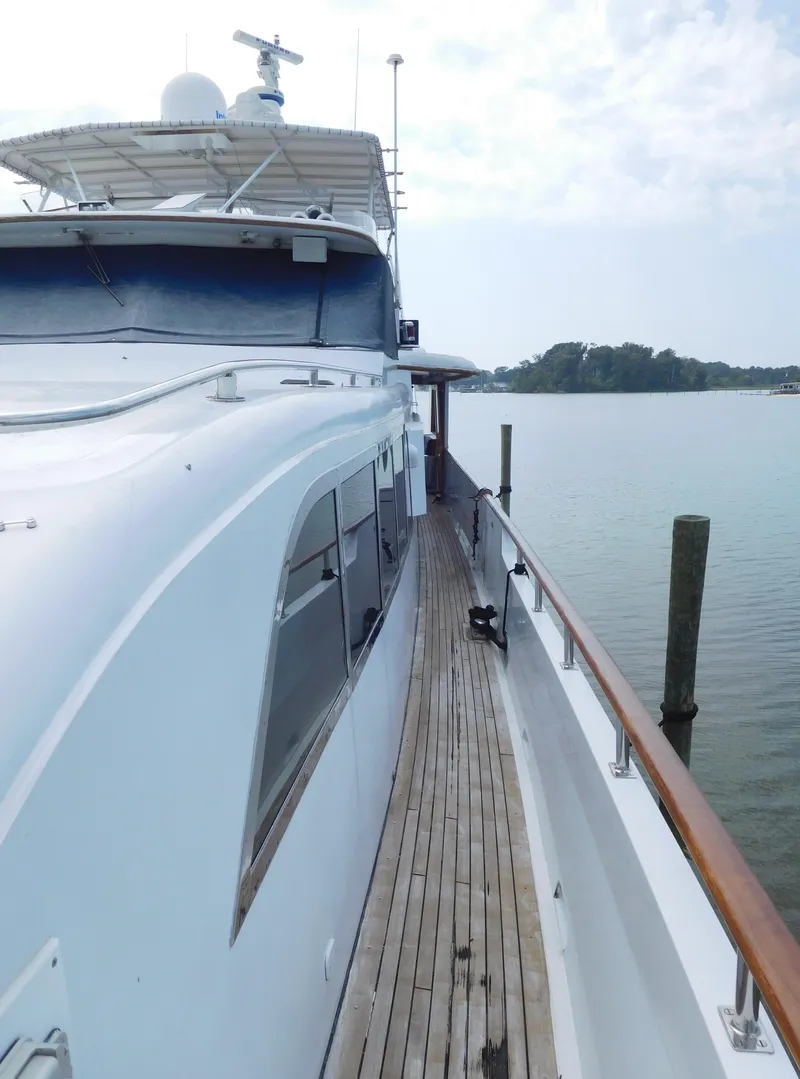 Slide: The Image of 1983 Cheoy Lee 90 cockpit motor yacht on calm water, side view. - 9
