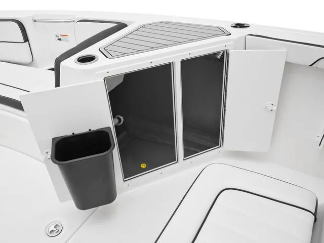 Slide: The Image of 2025 Yamaha Boats 222 FSH Sport interior storage compartment with open doors and trash bin. - 13