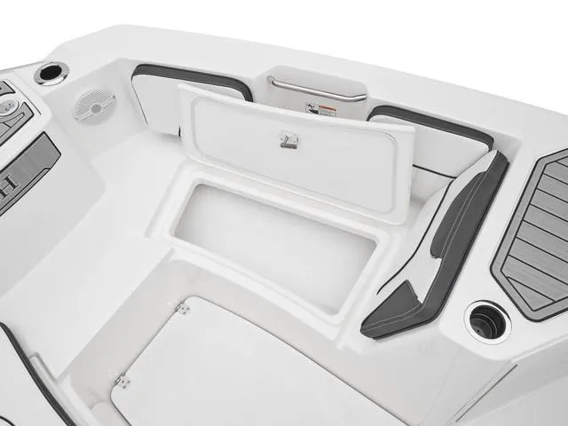 Slide: The Image of 2025 Yamaha Boats 222 FSH Sport interior storage compartment, sleek design, white and black accents. - 7