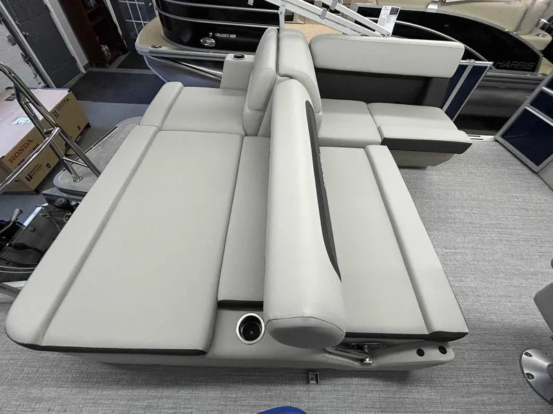 Slide: The Image of 2024 Harris Cruiser 190 boat interior with gray seating and cup holder. - 11
