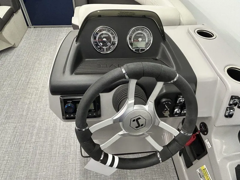 Slide: The Image of 2024 Harris Cruiser 190 dashboard with steering wheel and gauges. - 4