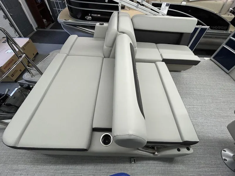 Slide: The Image of 2024 Harris Cruiser 190 boat interior with gray seating and cup holders. - 6