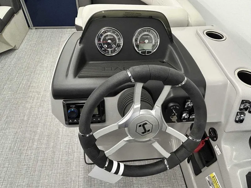 Slide: The Image of 2024 Harris Cruiser 190 dashboard with steering wheel and gauges. - 9