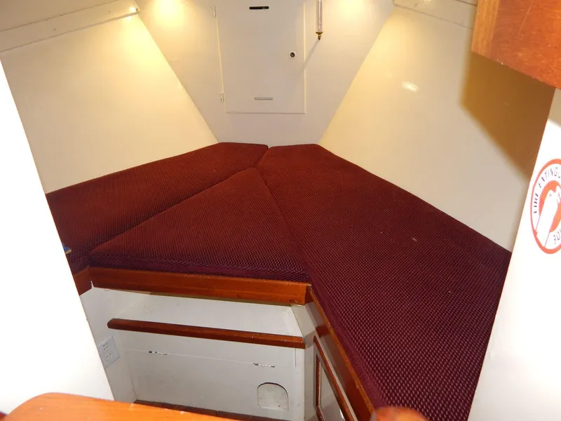 Slide: The Image of Interior cabin of 1963 Grand Banks 35 Chantyman with maroon cushions and wooden accents. - 5
