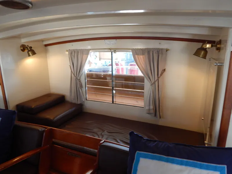Slide: The Image of Interior of 1963 Grand Banks 35 Chantyman with cozy seating and window view. - 7
