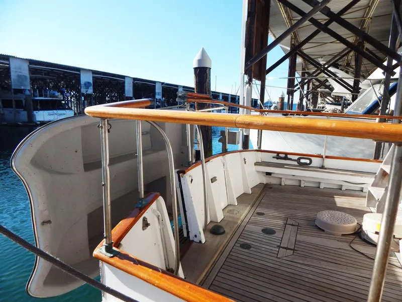 Slide: The Image of 1963 Grand Banks 35 Chantyman yacht deck with wooden railings and docked at marina. - 11