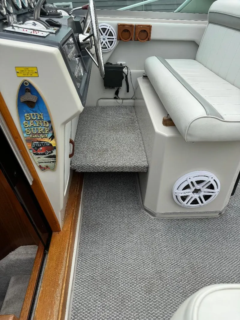 Slide: The Image of 1987 Sea Ray 340 Express Cruiser interior with gray carpet and white seating. - 20