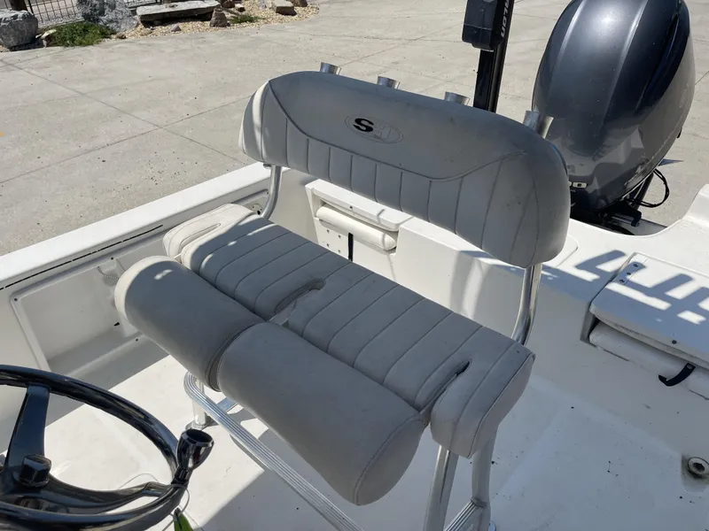 Slide: The Image of 2014 Sea Hunt Bay Boat BX 22 Pro interior with seating and motor. - 22