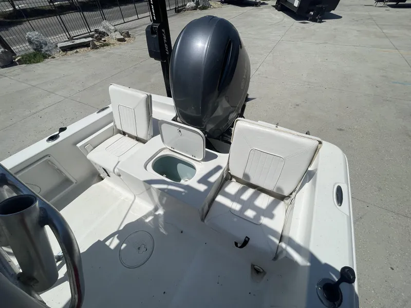 Slide: The Image of 2014 Sea Hunt Bay Boat BX 22 Pro with seating and motor, docked outdoors. - 24