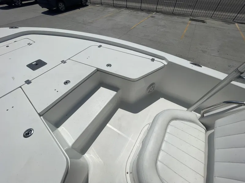 Slide: The Image of 2014 Sea Hunt Bay Boat BX 22 Pro interior with seating and storage compartments. - 26