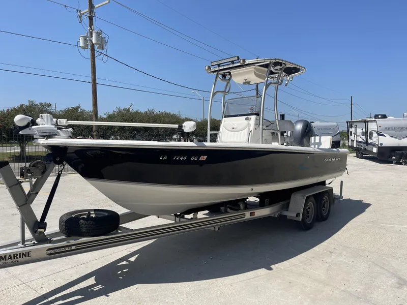 Slide: The Image of 2014 Sea Hunt Bay Boat BX 22 Pro on trailer in sunny outdoor setting. - 5
