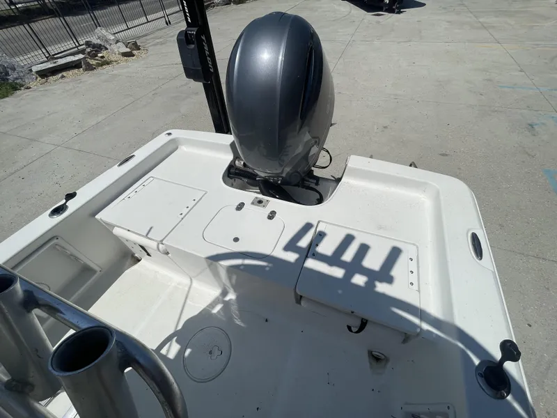 Slide: The Image of 2014 Sea Hunt Bay Boat BX 22 Pro with outboard motor in a parking area. - 8