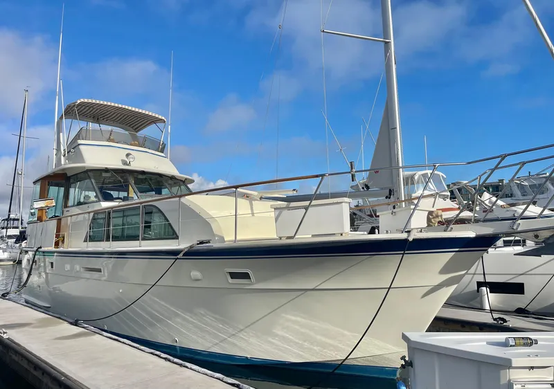 The Image of 1979 Hatteras 43 Motor Yacht docked at marina under blue sky. - 1