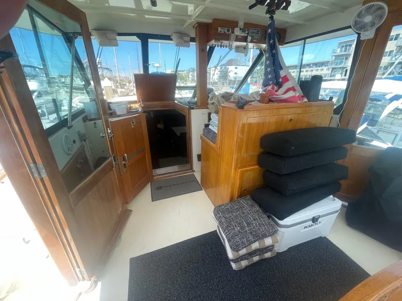 Slide: The Image of 1979 Hatteras 43 Motor Yacht interior with wooden cabinetry and nautical decor. - 10