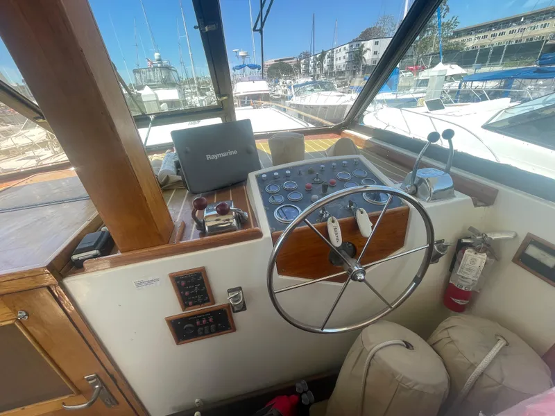 Slide: The Image of 1979 Hatteras 43 Motor Yacht helm with steering wheel, controls, and navigation equipment. - 11