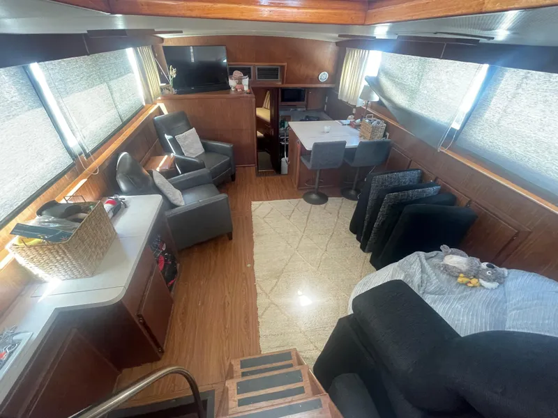 Slide: The Image of Interior of 1979 Hatteras 43 Motor Yacht with modern furnishings and ample natural light. - 14