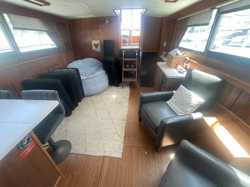 Slide: The Image of Interior of 1979 Hatteras 43 Motor Yacht with cozy seating and natural light. - 15