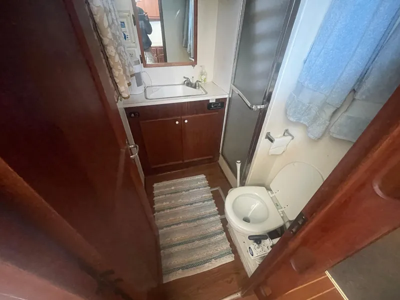 Slide: The Image of Bathroom interior of 1979 Hatteras 43 Motor Yacht with sink, toilet, and shower. - 18