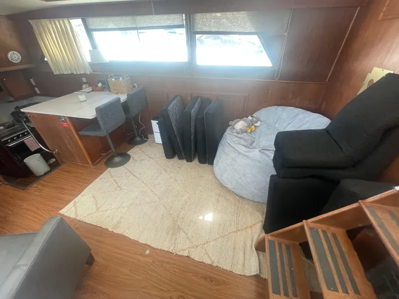 Slide: The Image of Interior of 1979 Hatteras 43 Motor Yacht with seating, table, and windows. - 22