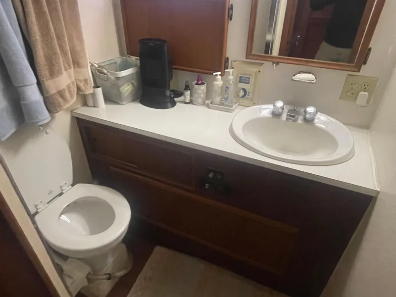Slide: The Image of 1979 Hatteras 43 Motor Yacht bathroom with sink, toilet, and toiletries. - 25