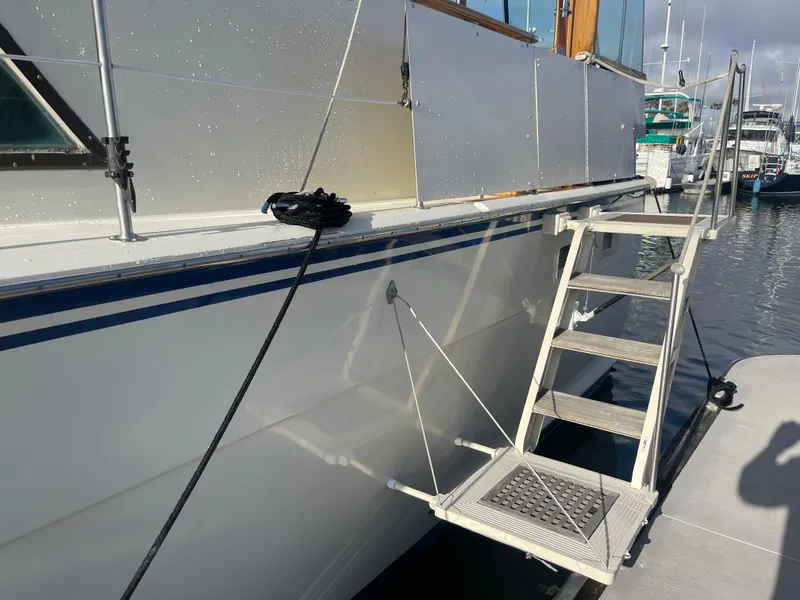 Slide: The Image of 1979 Hatteras 43 Motor Yacht docked with boarding ladder in marina. - 3