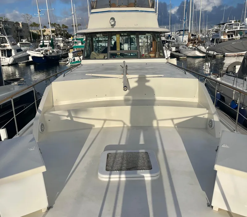 Slide: The Image of 1979 Hatteras 43 Motor Yacht docked in a marina, sunny day. - 4