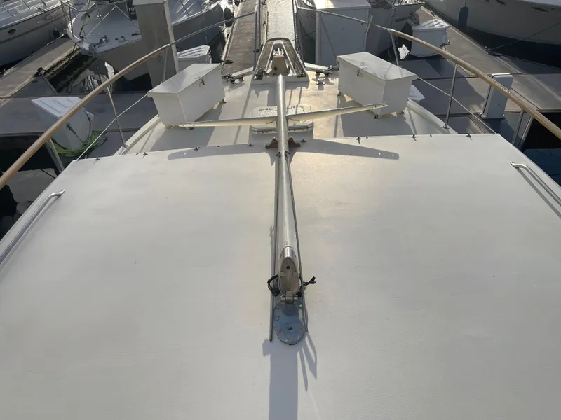 Slide: The Image of 1979 Hatteras 43 Motor Yacht deck view with railing and docked boats. - 5