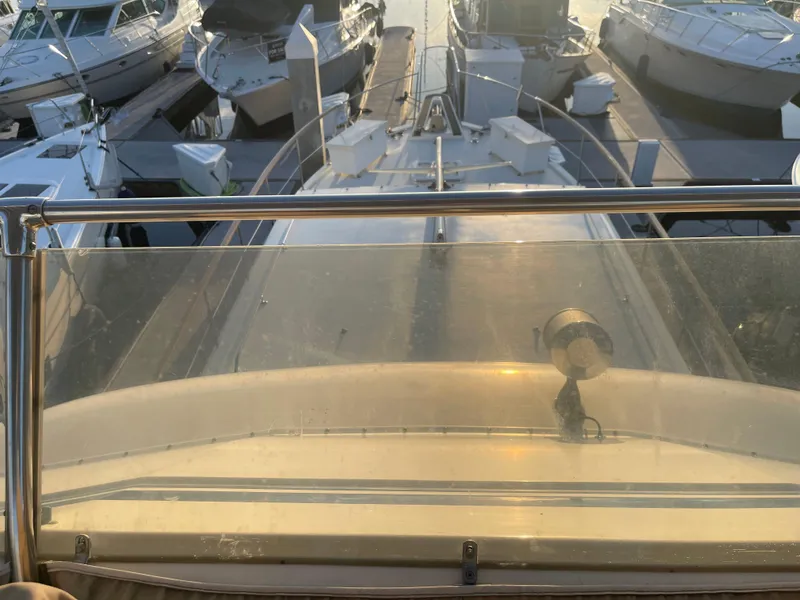 Slide: The Image of 1979 Hatteras 43 Motor Yacht docked, viewed from the upper deck at sunset. - 8