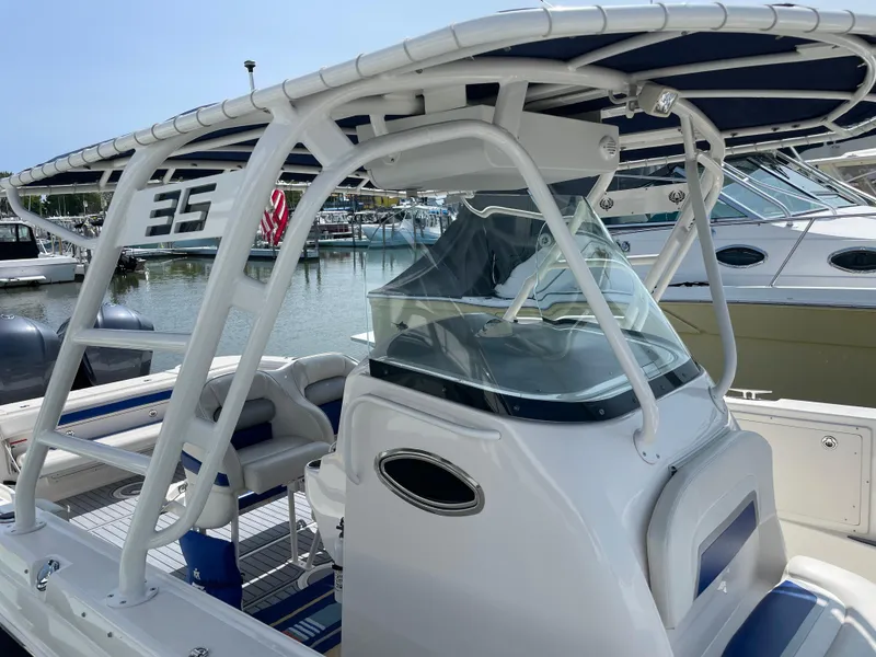 Slide: The Image of 2015 Wellcraft 35 Scarab boat with sleek design, docked in a marina. - 11