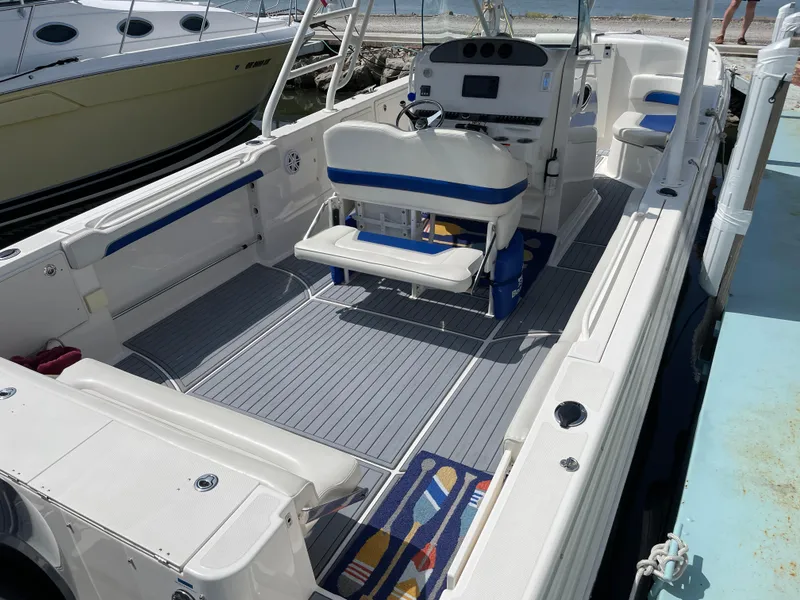 Slide: The Image of 2015 Wellcraft 35 Scarab boat interior with seating and control panel, docked at marina. - 17