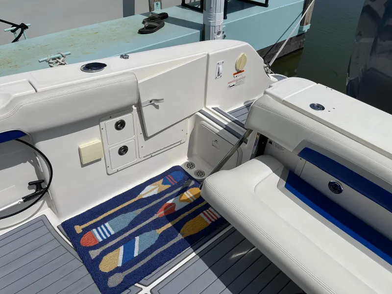Slide: The Image of 2015 Wellcraft 35 Scarab boat interior with nautical-themed mat and white seating. - 22
