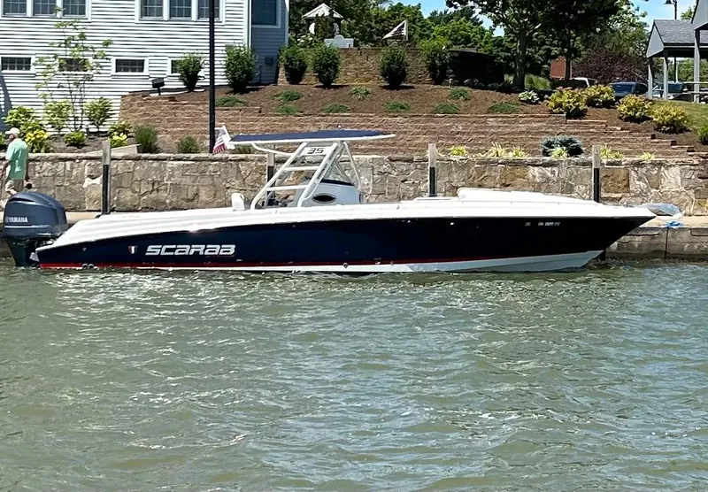 Slide: The Image of 2015 Wellcraft 35 Scarab boat docked by a waterfront home. - 4