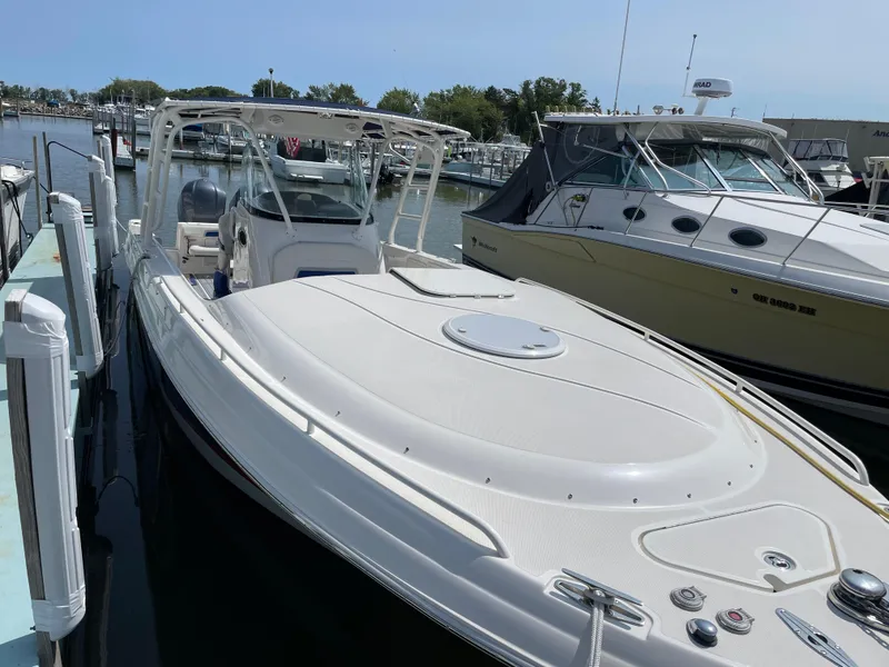 Slide: The Image of 2015 Wellcraft 35 Scarab boat docked at marina, sleek design, sunny day. - 6